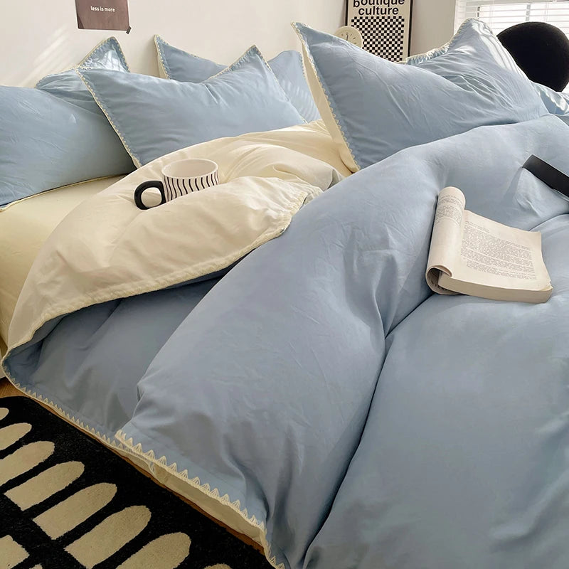 A close-up of a light blue luxurious washed cotton bed linen set featuring pillows and a duvet on a bed.