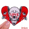Red embroidered skull patch with the word LOVE on a white background
