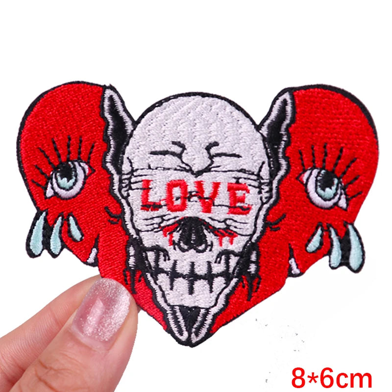 Red embroidered skull patch with the word LOVE on a white background