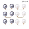 A set of six pearl-like round jewelry pieces with gold-toned findings.