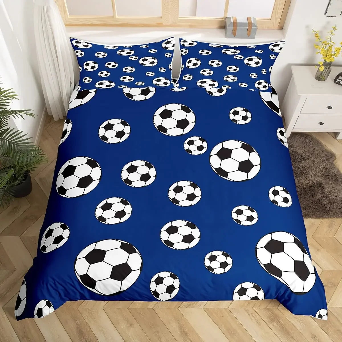 A royal blue duvet cover featuring a pattern of black and white footballs.