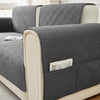 Gray geometric quilted sofa cushion covers on a light-colored sofa.