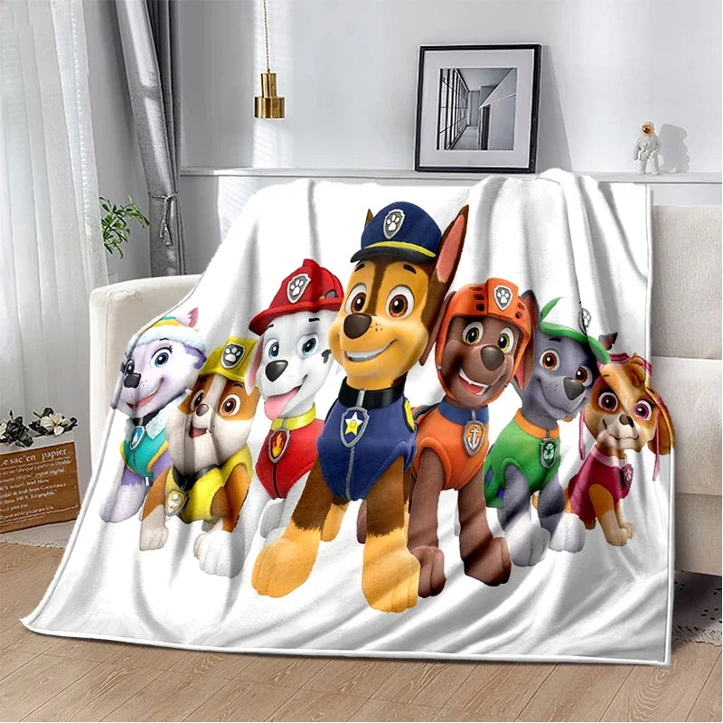 A white flannel throw blanket featuring a cartoon dog plush characters in various poses.