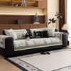 A beige sofa with a white and green Christmas deer pattern mat cover sits in a modern living room.
