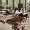 A brown and white faux animal skin rug is displayed on a light wood floor in a modern living space.