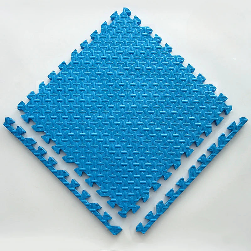 A bright blue interlocking foam play mat shaped like a diamond, designed for babies and toddlers.