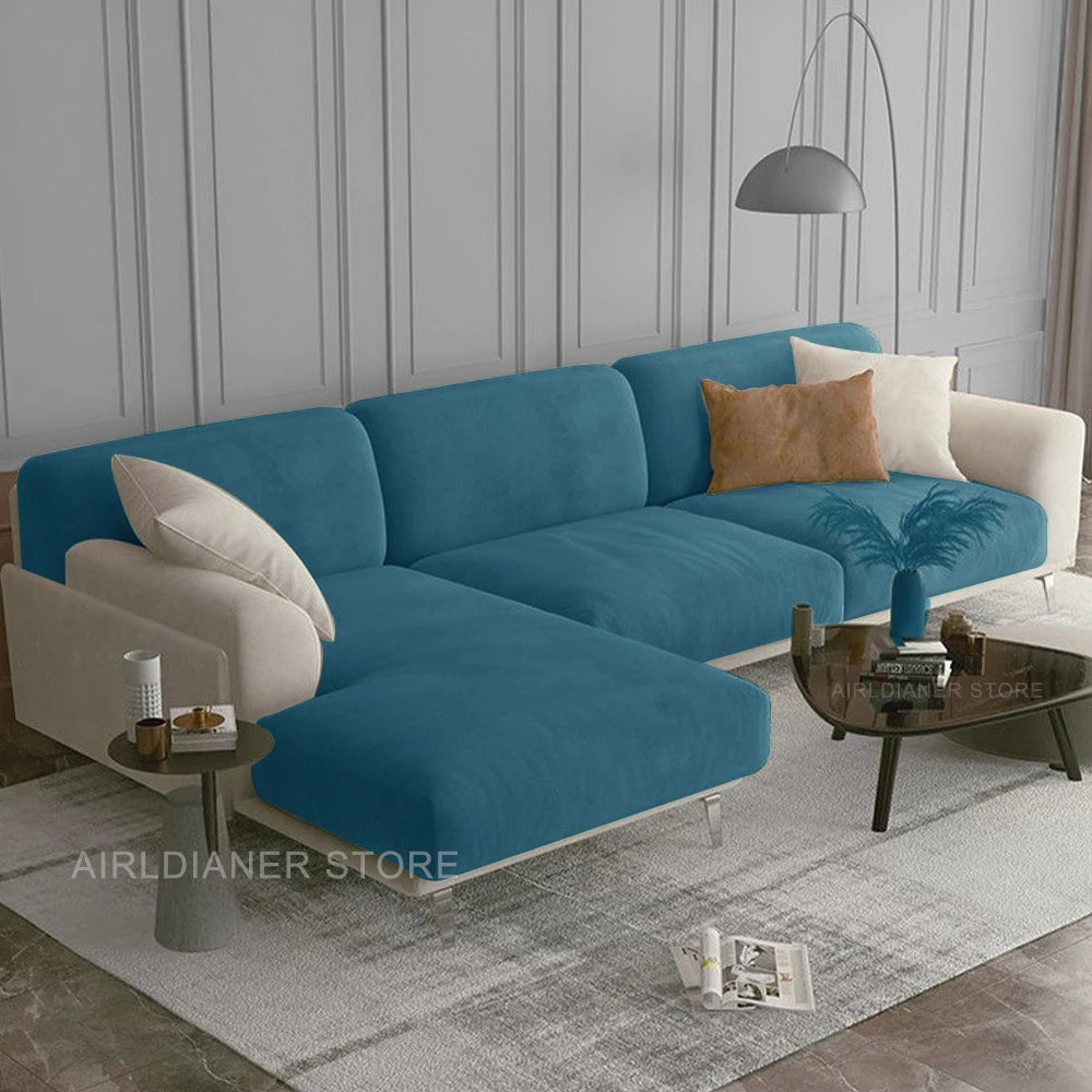 A modern teal velvet sofa seat cover displayed on a light gray rug in a well-lit room.