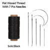 Solid black flat waxed thread with seven sewing needles on a spool.