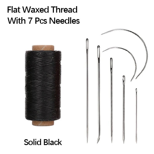 Solid black flat waxed thread with seven sewing needles on a spool.