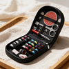 A black multi-functional sewing kit with scissors, needles, and thread spools is displayed on a wooden tray.