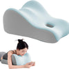 A light blue memory foam wedge pillow is shown next to a person using it for support.