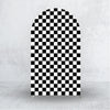 A tall arch backdrop covered in a black and white checkerboard pattern.