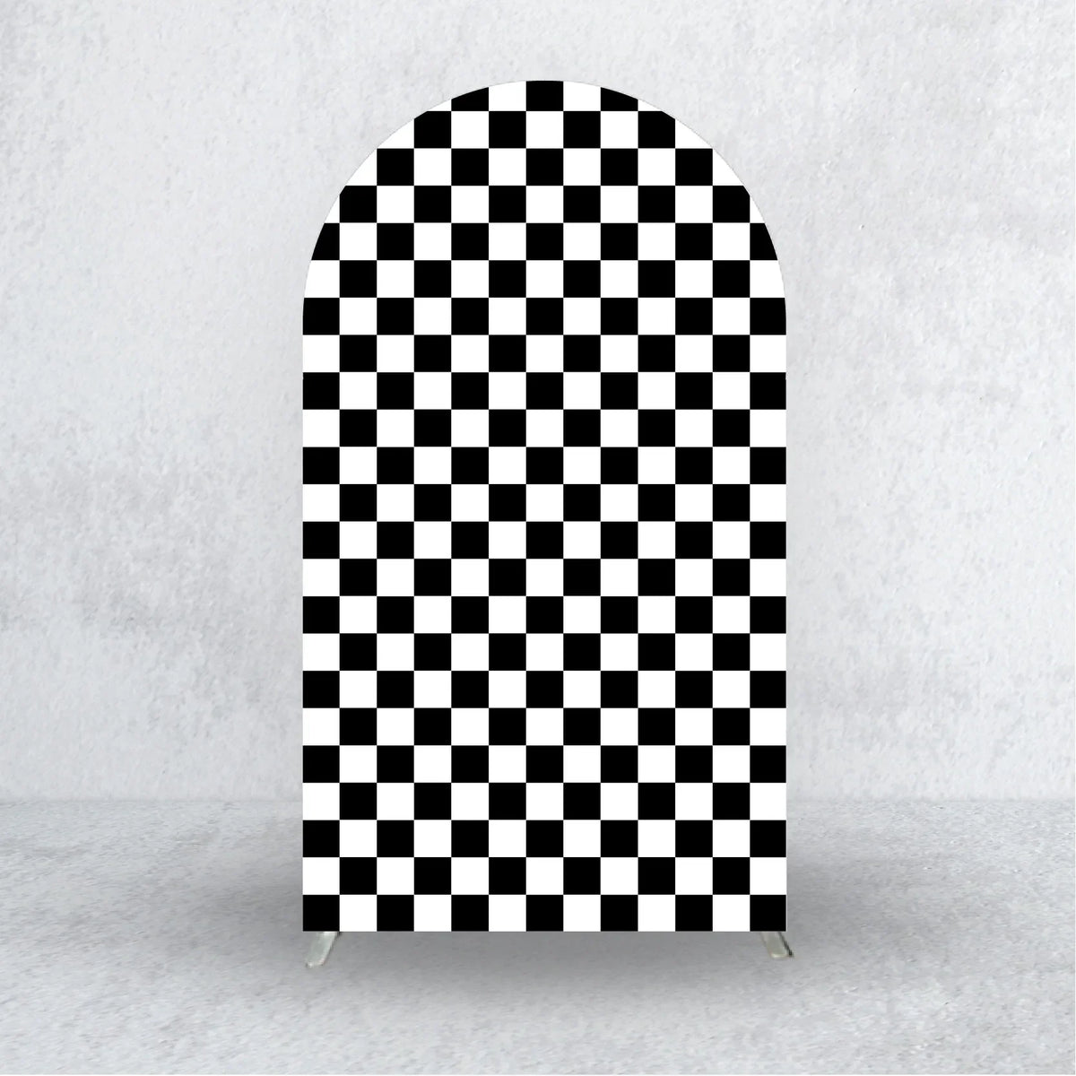 A tall arch backdrop covered in a black and white checkerboard pattern.