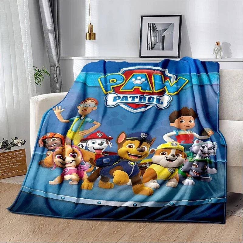 A colorful Paw Patrol themed flannel throw blanket featuring characters like Chase and Marshall.