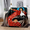 A blanket featuring a vibrant illustration of a person with dark curly hair wearing a red jacket and white shirt against a bl