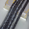 Black crystal beaded string curtain with clear glass tassels displayed next to a box.
