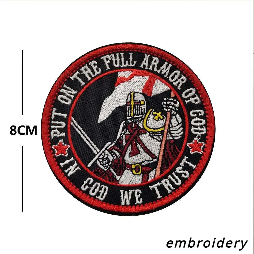 An embroidered patch featuring a warrior figure and text that reads Put on the full armor of God we trust