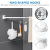 Ring shaped hooks hanging white fabric on a silver rod against a gray wall