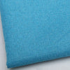 A close-up of a teal blue coarse linen and cotton fabric textile.