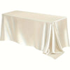 A smooth, beige satin tablecloth draped elegantly on a rectangular table.