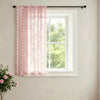 Pink vintage French-style lace curtain with a wave border hanging in a white window frame.