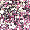 A pile of mixed clear and pink glass rhinestones for DIY crafts.