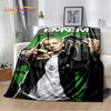 A black and green graphic throw blanket featuring a portrait of a man with a vintage aesthetic.