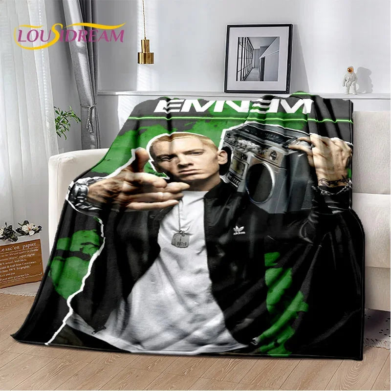 A black and green graphic throw blanket featuring a portrait of a man with a vintage aesthetic.