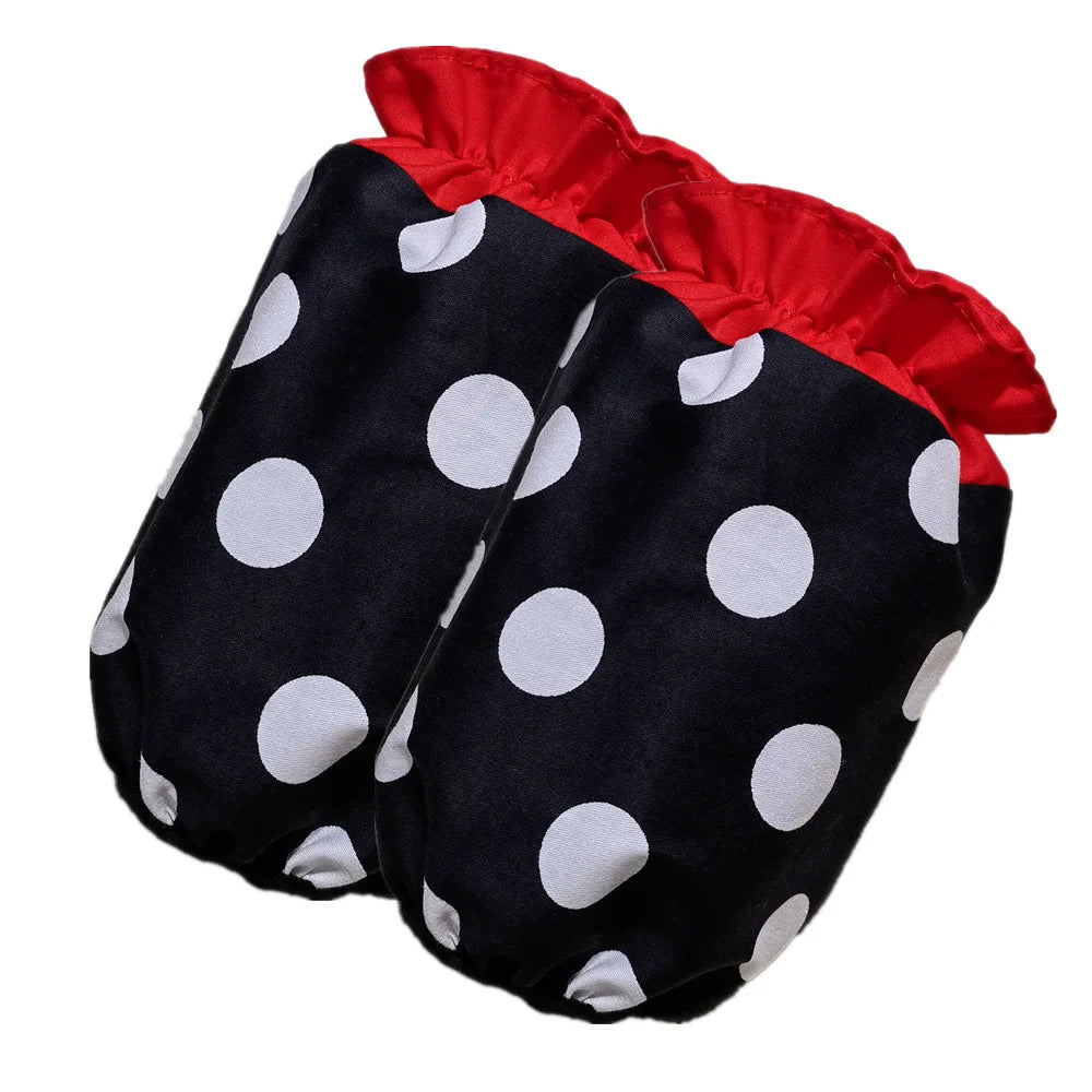 A pair of black polka dot ruffle apron pants with red trim and pockets.