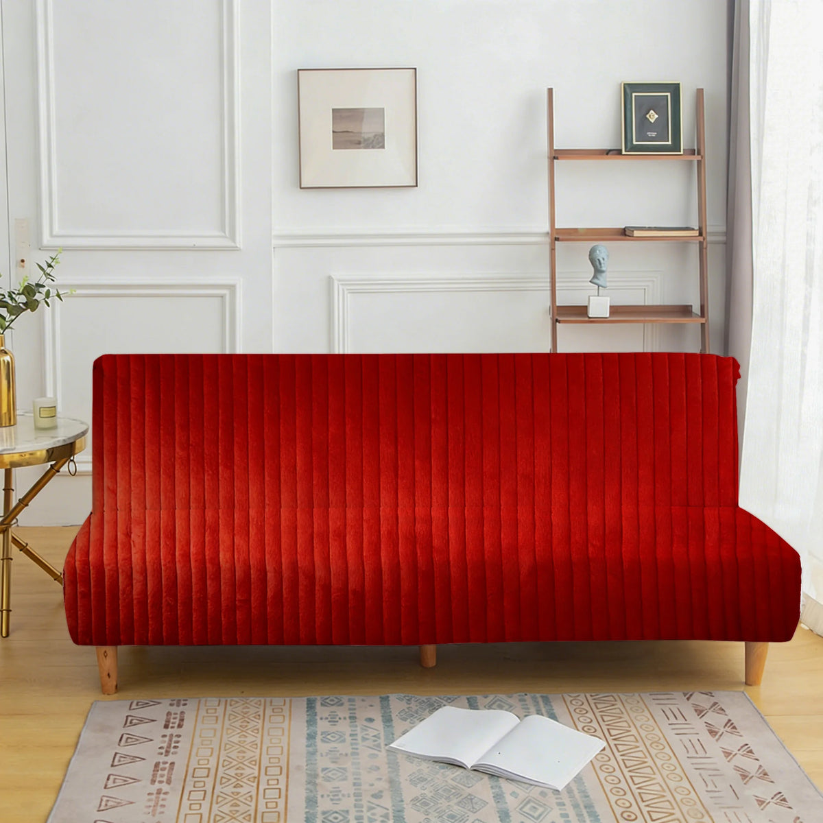 A vibrant red velvet armless sofa cover displayed in a bright interior setting.