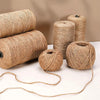 Rolls of natural jute twine used for crafts and decor, showing various sizes and a loose strand.