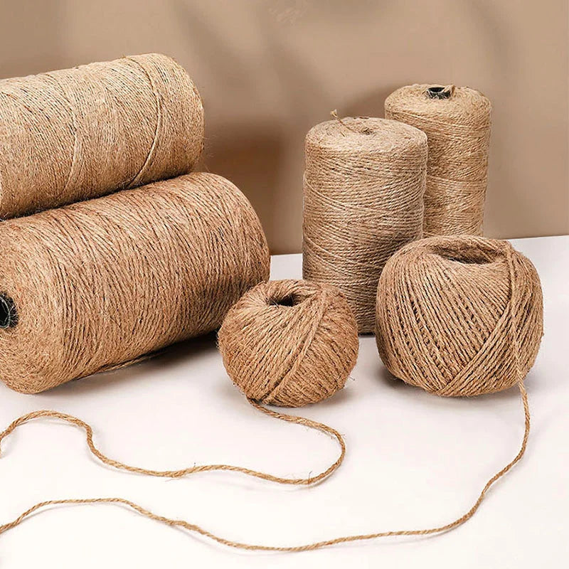 Rolls of natural jute twine used for crafts and decor, showing various sizes and a loose strand.