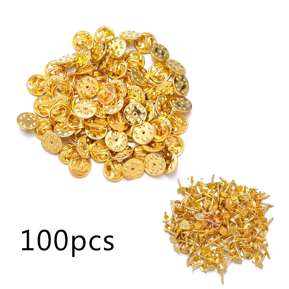 A pile of 100 gold-colored butterfly brooch clasps and tie tacks for jewelry making.