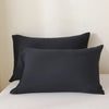 A set of three black luxury polyester pillow covers displayed on a white surface.