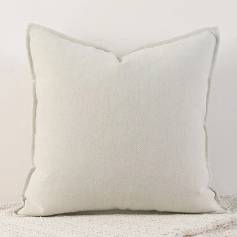 A solid white chenille throw pillow cover with a subtle Nordic striped texture.