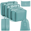 A set of teal travel storage organizers including a zippered pouch and several rectangular storage boxes.