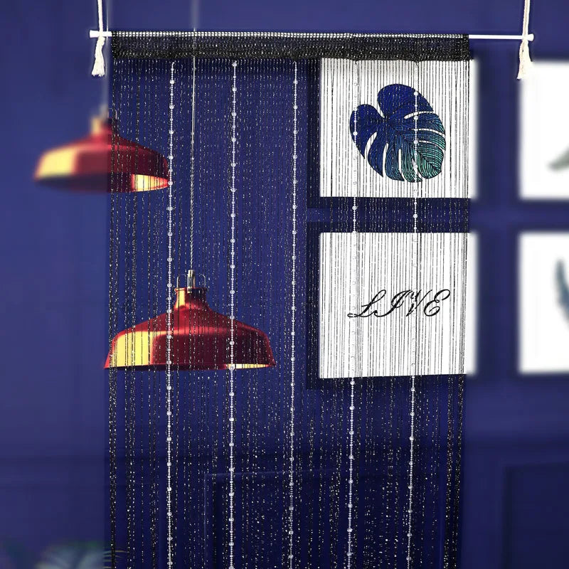 Blue beaded string curtains featuring a white leaf design and decorative elements.