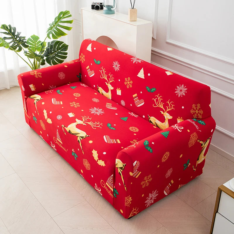 A bright red stretchable festive sofa cover featuring reindeer and snowflake patterns on a white wooden shelf.