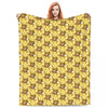 A yellow cartoon pattern throw blanket featuring cute bear faces.