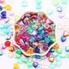A pile of colorful acrylic heart beads in various shades of pink, blue, green, and yellow for jewelry making.