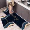 Two dark blue and gold diamond print non-slip kitchen rugs displayed on a light wood floor.