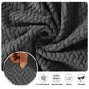 Close-up view of a thick gray jacquard sofa cover fabric showing its texture and weave.
