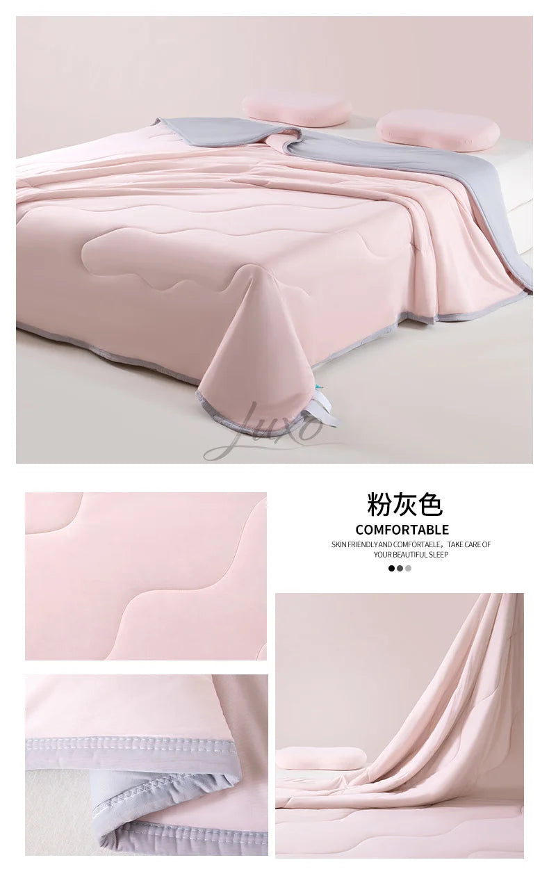 Pink ice silk summer cooling blanket draped on a bed, showing soft texture and light gray trim.