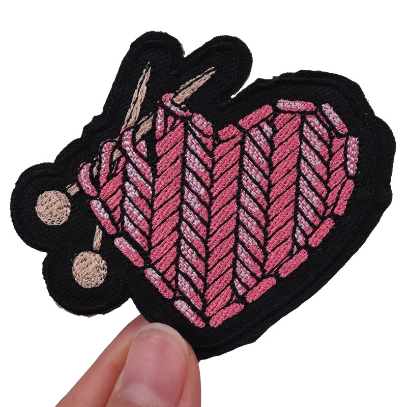 Black embroidered heart patch with pink and beige thread detailing