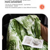 A green and white striped multi-functional blanket draped over a surface.
