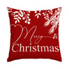 A red pillow featuring white holiday foliage and the text Merry Christmas