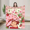 A pink strawberry shortcake themed throw blanket featuring a cute illustration of a strawberry character.