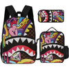 A set of black graphic print backpacks featuring colorful dinosaur or monster faces and patterns.