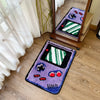 A purple tufted floor mat featuring pixelated graphics of video game elements and striped patterns.