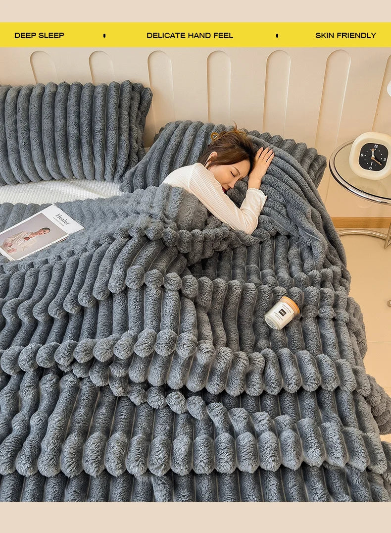 A gray fluffy blanket is draped over a bed, emphasizing deep sleep and skin friendly features.